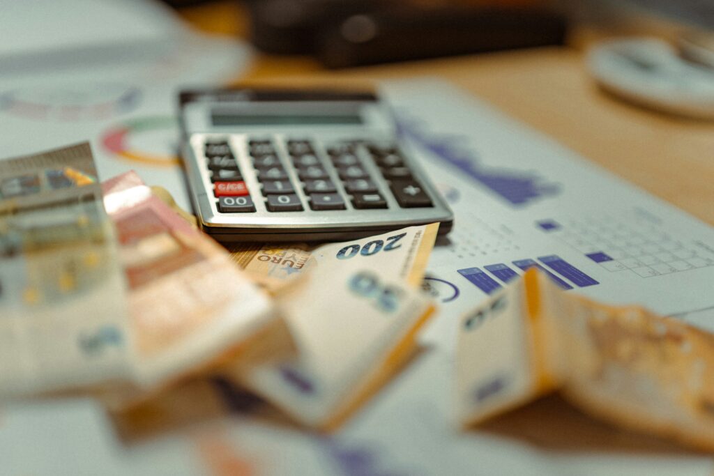 A person planning a simple monthly budget at a desk.